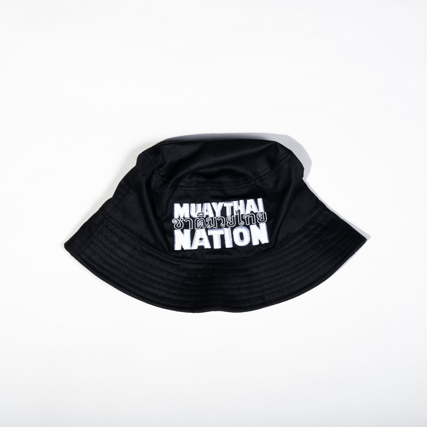 Muay Thai Nation black 100% cotton bucket hat featuring bold stacked white embroidered brand logo text