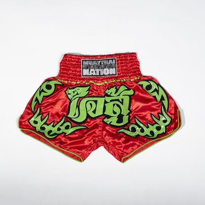 A pair of Muay Thai shorts featuring a satin fabric with a red, green, and white color scheme. The shorts have floral patterns and text that reads 'Muay Thai Nation' and 'BANGKOK'.