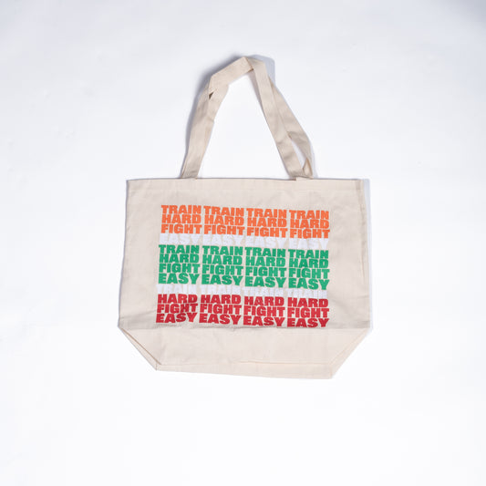 Muay Thai Nation Lucky 7 canvas tote bag featuring stacked retro orange green and red text graphics