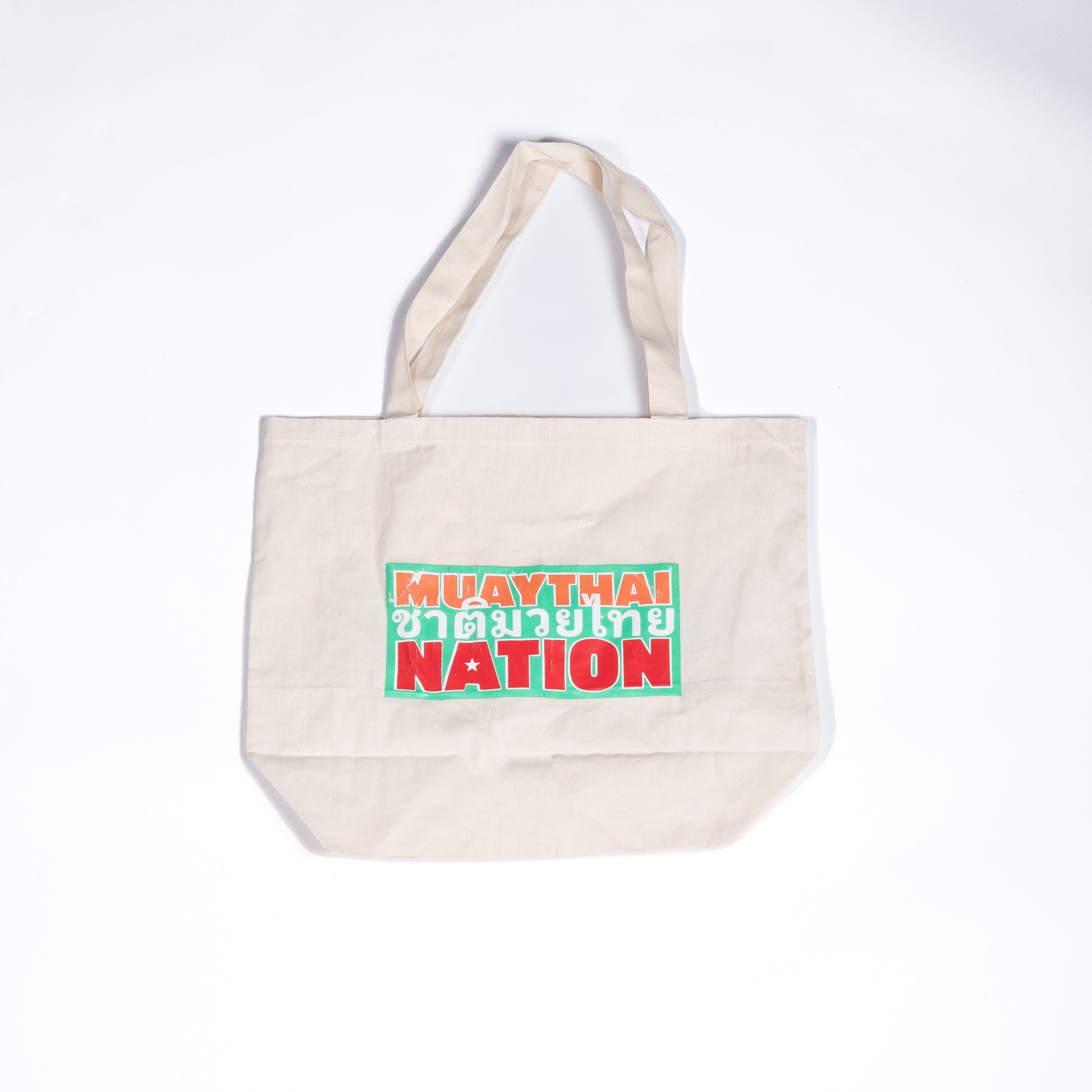 Muay Thai Nation Lucky 7 canvas tote bag featuring stacked retro orange green and red text graphics