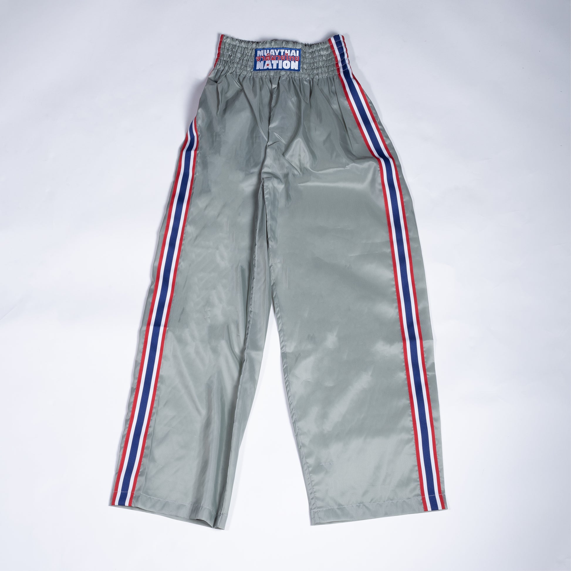 Muay Thai Nation light grey tracksuit pants with blue, white, and red trim 