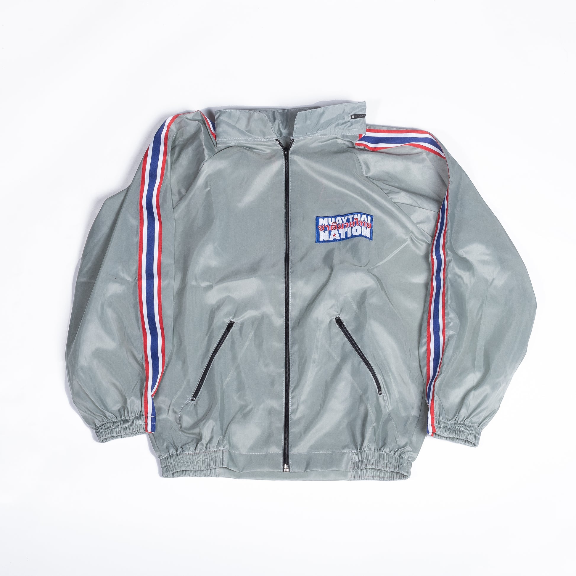 Muay Thai Nation light grey tracksuit jacket with blue, white, and red trim front view