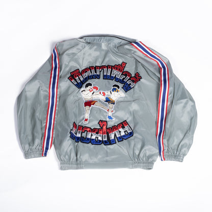 Muay Thai Nation light grey tracksuit jacket with blue, white, and red trim back view