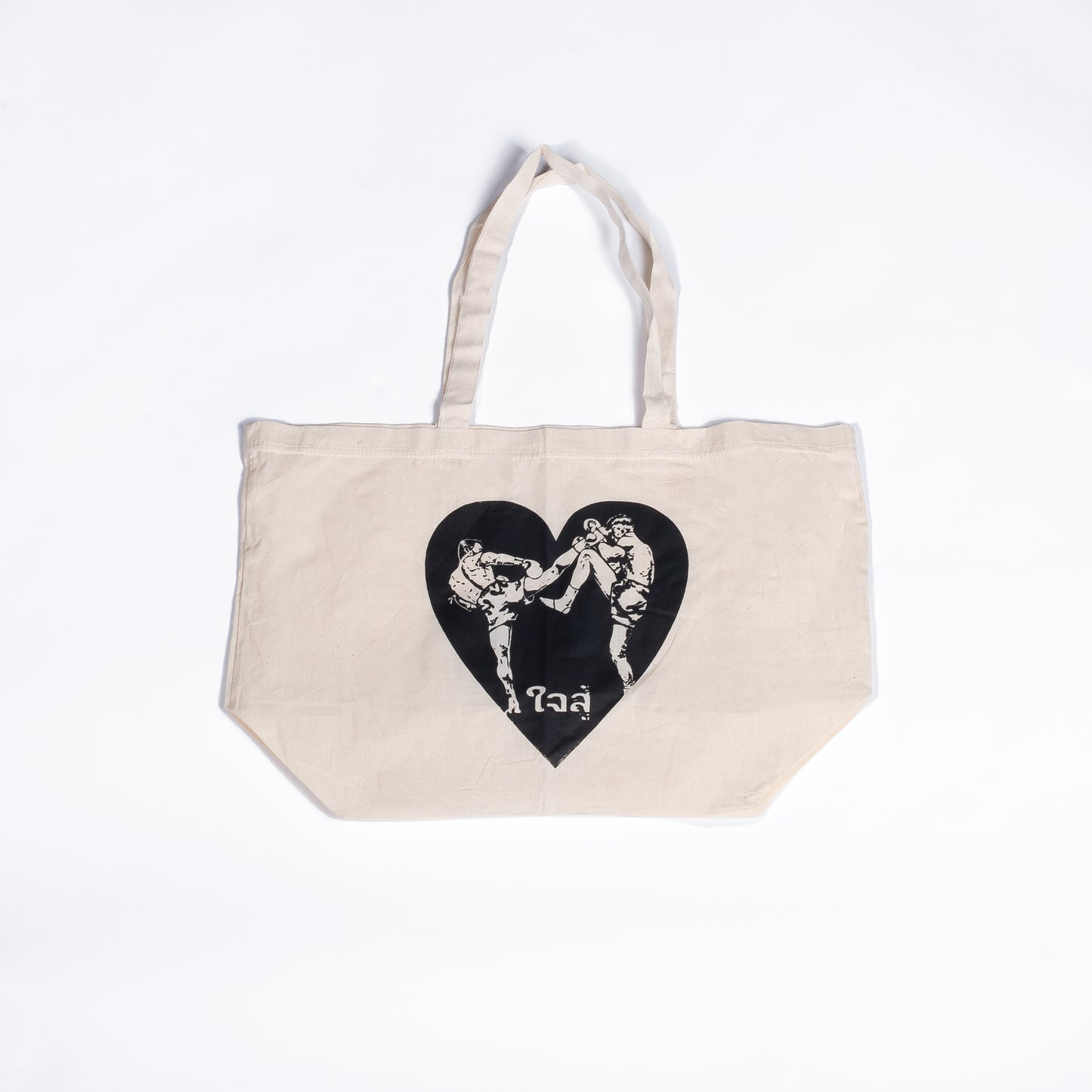 Muay Thai Nation off-white canvas tote bag featuring a black graphic heart design with traditional Thai script text