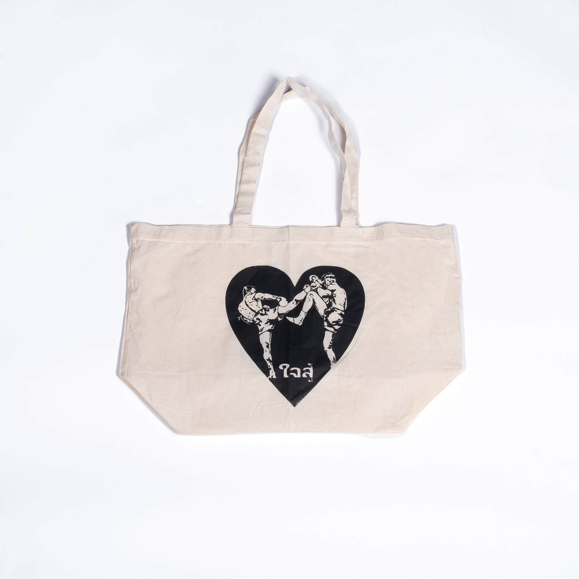 Muay Thai Nation off-white canvas tote bag featuring a black graphic heart design with traditional Thai script text