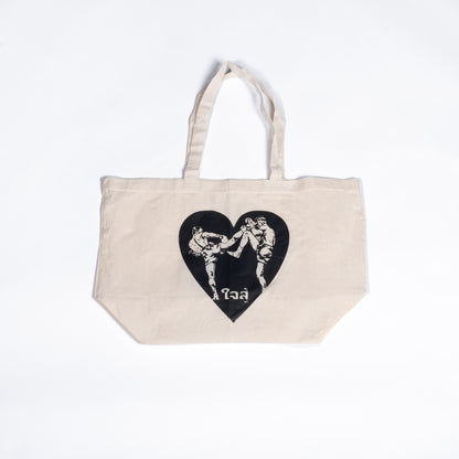 Muay Thai Nation off-white canvas tote bag featuring a black graphic heart design with traditional Thai script text