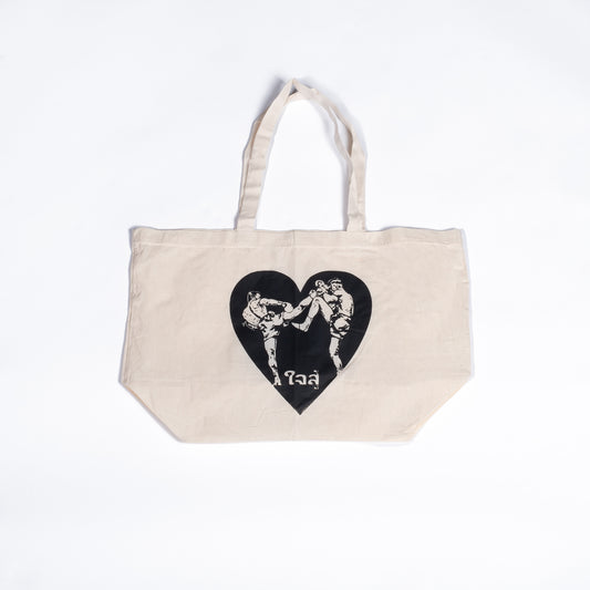 Muay Thai Nation off-white canvas tote bag featuring a black graphic heart design with traditional Thai script text