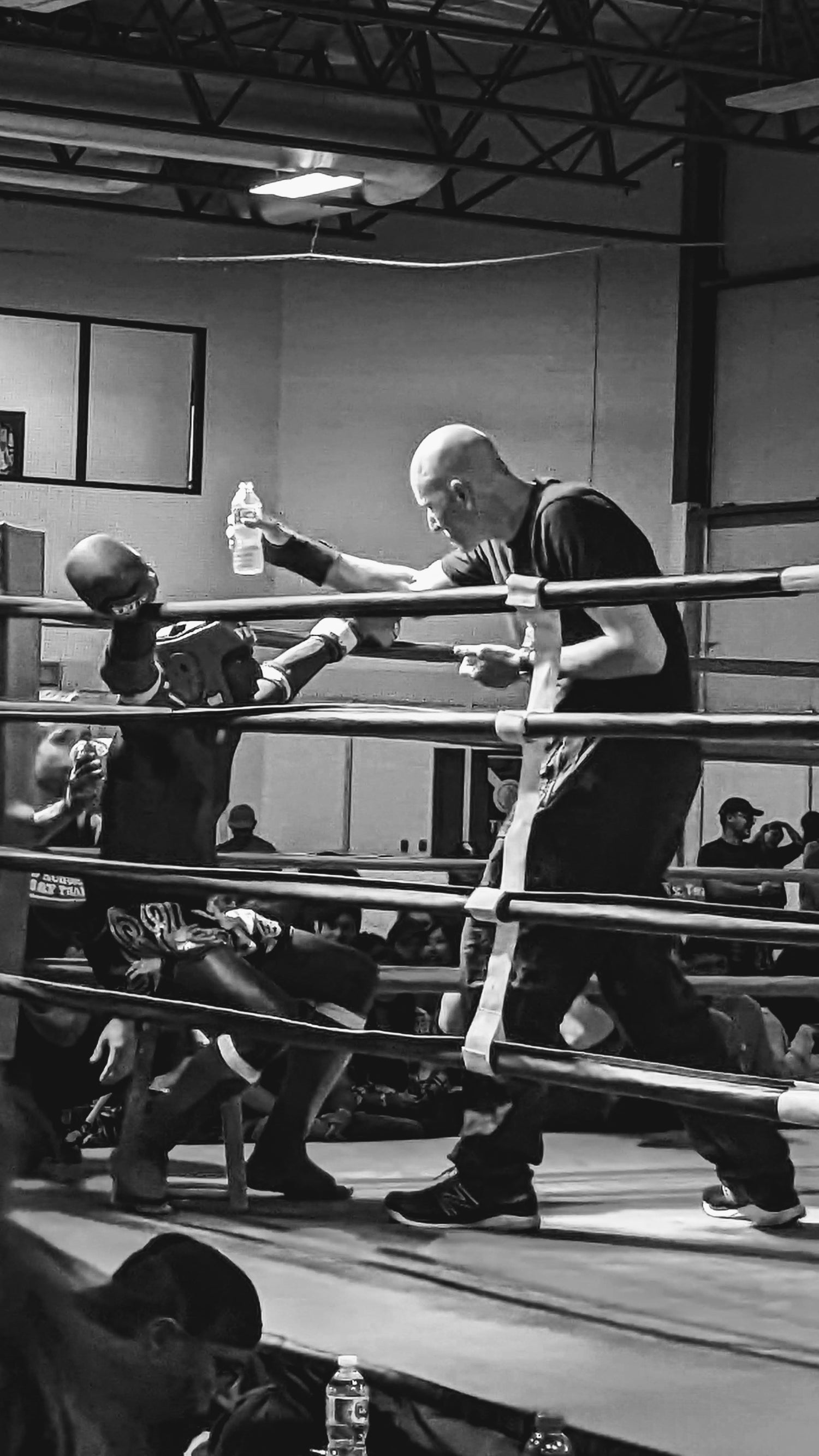 Muay Thai athletes training and sparring in a boxing ring, representing the discipline and spirit of Muay Thai Nation.