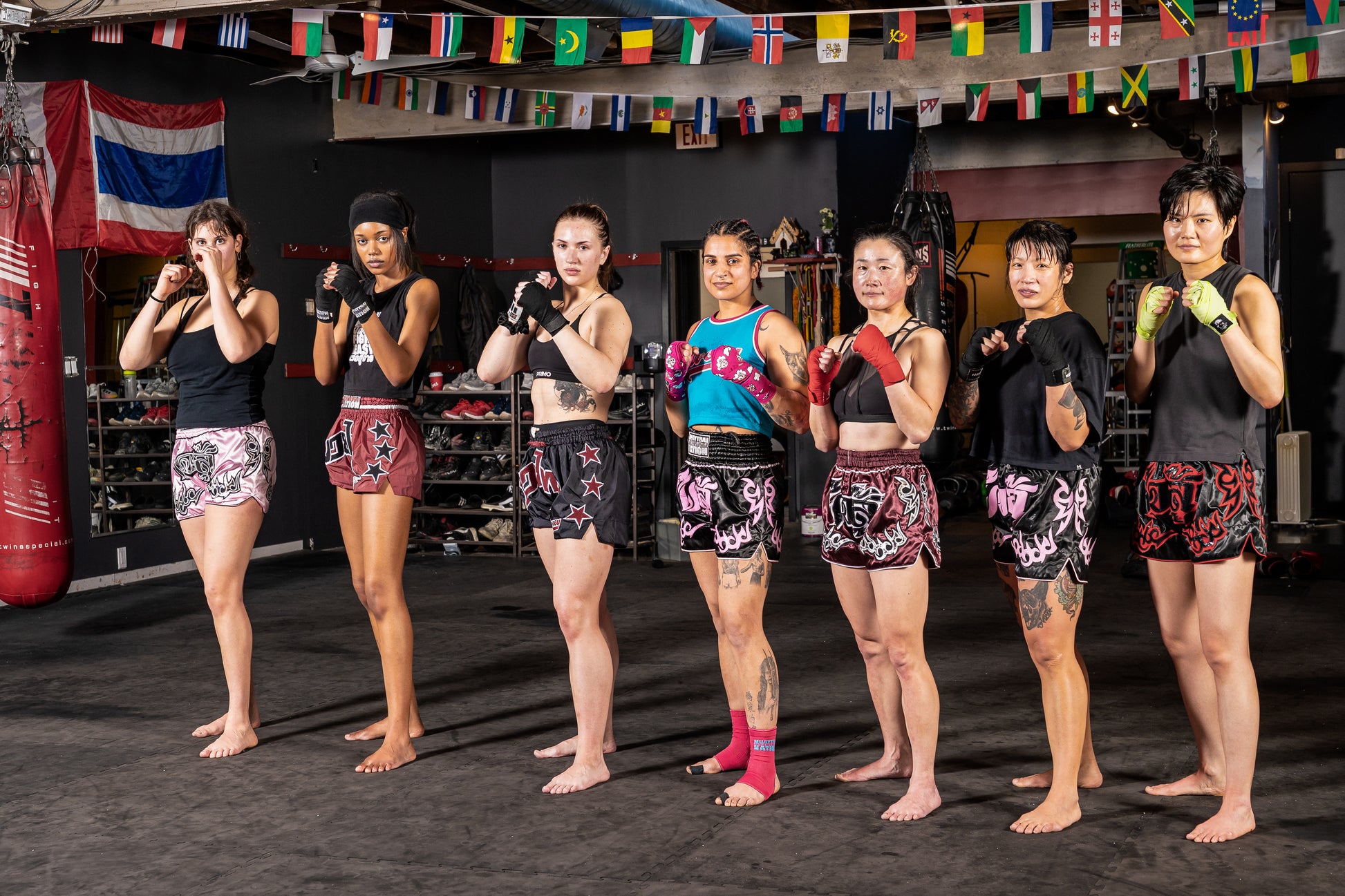 Women's muay thai fighters wearing colourful muay thai shorts paired with custom muay thai hand wraps.
