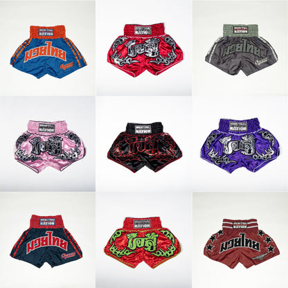 Collection of colorful muay thai shorts with brand logo on a white background